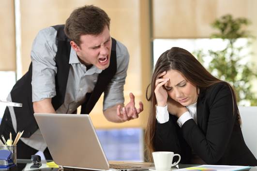 Man yelling at upset female coworker - Hostile Work Environment